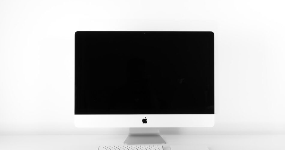 MacBook Pro connected to dual external monitors via hub dock workstation setup