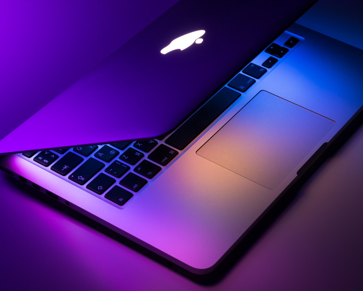 MacBook Air and Windows laptop side by side on modern office desk