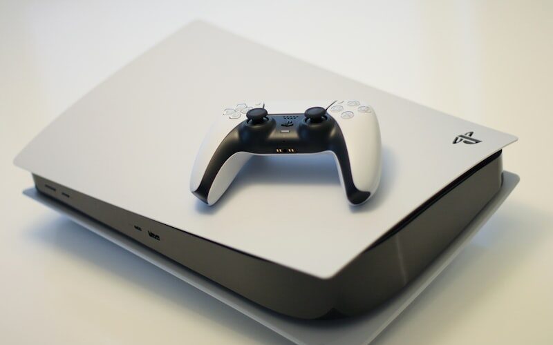 PlayStation 5 and gaming console controllers on desk